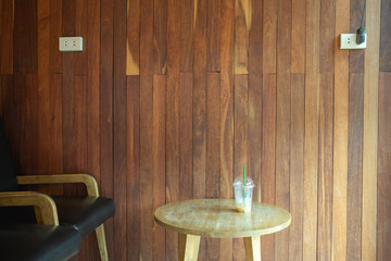 empty ice coffee on wooden table and wooden backfround