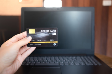 close up asian women holding credit card for shopping online with computer