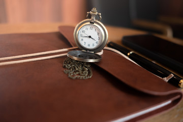 focus pocket vintage watch and defocus accessory of business on wooden table