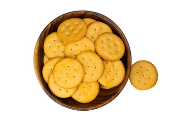Top view of crunchy round crackers in wooden bowl on white background with clipping path.
