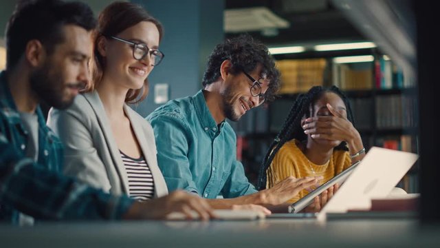 Diverse Team of Young Brilliant Entrepreneurs and Office Specialists Have a Meeting, Talking, Using Digital Tablet Computer, Finding Solutions and Solving Problems. Talented Young People Working