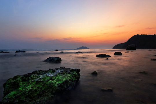 Sea sunset with rock green moss beautiful, krating bay &lrm;Chanthaburi thailand.