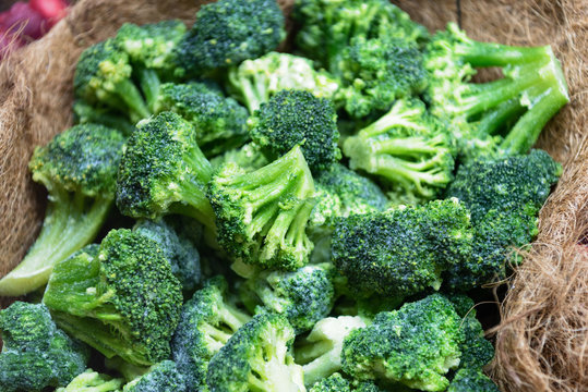 Fresh frozen broccoli. Inflorescences of cabbage are stacked in a bunch in a decorative burlap.