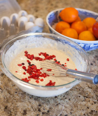 pancake batter with raspberries and oranges and eggs