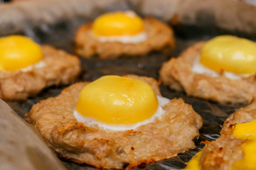 Raw egg on a cutlet close up before going to the oven.Idea for a healthy dinner.Concept ketogenic diet.Selective focus 