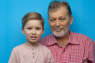 Portrait of cute positive grandfather and grandson