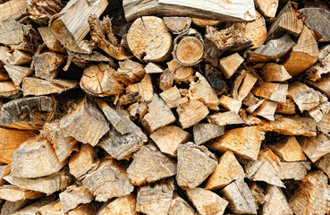 Background of wooden logs. Pile chopped dry firewood on stack. rustic woodpile scene. template for design