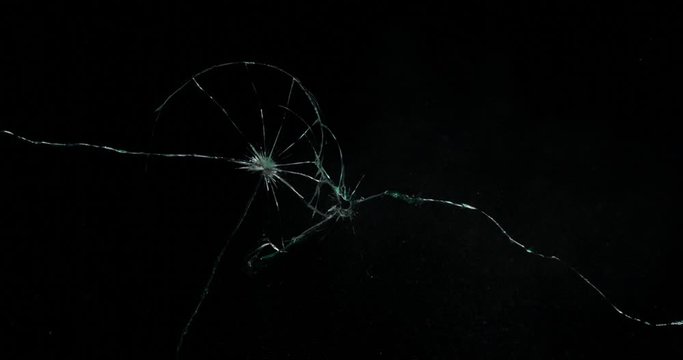 Broken cracks glass fracture effect texture isolated abstract black background. Bullet cracked window with big hole screen mirror weapon shot.
