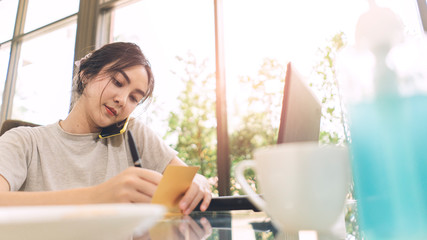 Coronavirus. Business woman working from home. Asian woman in quarantine for protective coronavirus. Cleaning her hands with sanitizer gel. Asian woman student leaning online at home.
