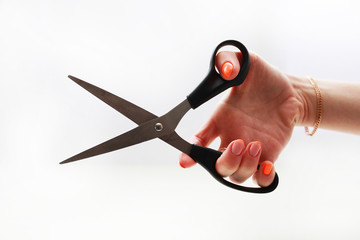 female hand holds cuts with scissors