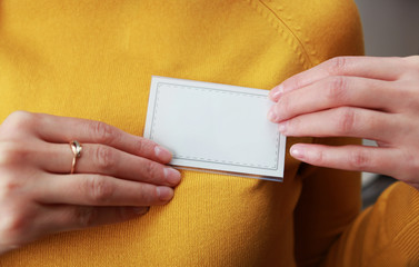female hands holding a badge