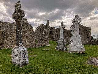 Cloudy gloomy view of cemetery at the Clonmacnoise historic monastery ruins in County Offaly,...