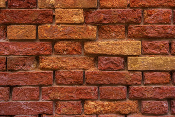 An old Venetian brick wall. Background with crumbling brickwork.