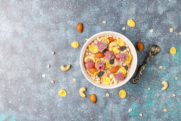 Healthy breakfast. Fresh granola, muesli with nuts and frozen berries. Top view. Copy space.