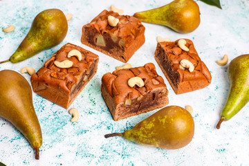 Homemade rustic chocolate cake with pear and cashew nuts,top view