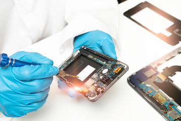 The abstract image of the technician repairing mobile phone in electronic smartphone technology