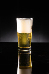 glass of beer on dark background