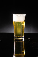 glass of beer on dark background