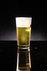 glass of beer on dark background