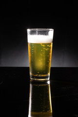 glass of beer on dark background