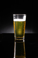glass of beer on dark background