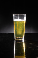 glass of beer on dark background