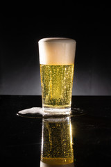 glass of beer on dark background