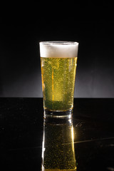 glass of beer on dark background