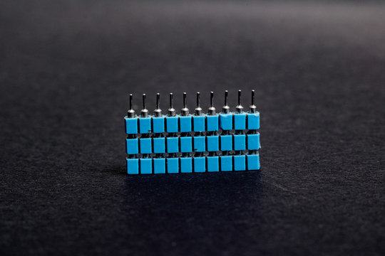 Stack of blue electronic engineering connectors close up
