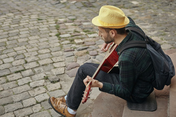 Lovely young street musician with guitar