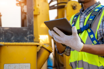Engineer builder using tablet working outdoors, Construction Concept. © visoot