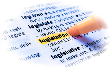A close up of the word: LEGISLATION in a dictionary, highlighted in yellow and showing part of its...