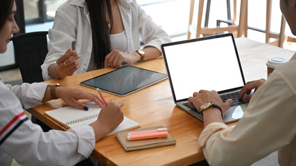 Business developer team working together at meeting table with computer laptop and tablet. Collaboration in office concept.