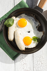 Fried eggs, sausage in iron pan -  Healthy food english breakfast. Colorblock