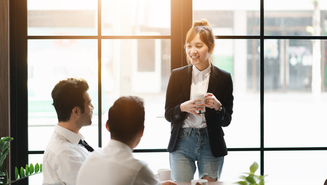 Young asian business group discussion in office workplace. lifestyle social distance friends meeting corporate office.