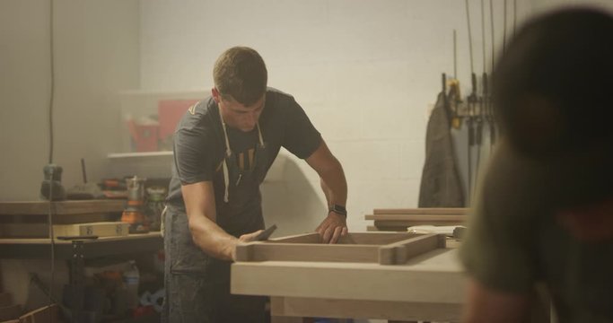 Woodworker men working in garage