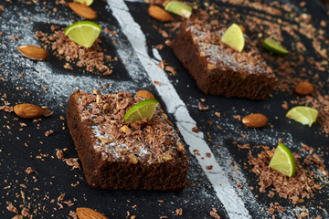 brownies whit lemon on black table