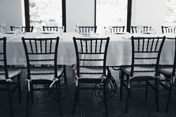 Empty hall of the restaurant. A table is served awaiting guests. Pandemic of new coronavirus crippling restaurant business