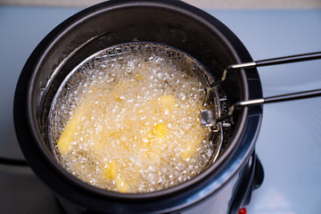 French fries. oil boiling in a deep fryer at home.