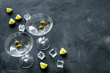 Martini with olives and ice on grey background copy space
