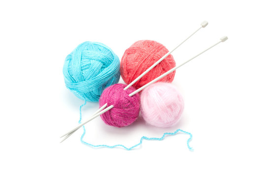 Multicolored yarn balls and needles .