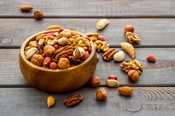 Mixed nuts in bowl - healthy snack - on wooden background