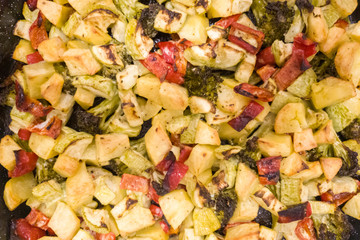 Vegetable stew, oven baked vegetables. Finely chopped and seasoned potatoes, bell peppers, zucchini and broccoli. Healthy food close-up