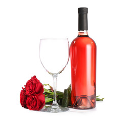 Glass and bottle of wine with rose flowers on white background
