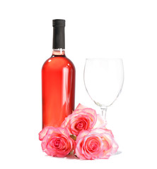 Glass and bottle of wine with rose flowers on white background