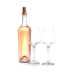 Glasses and bottle of wine on white background