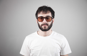 Caucasian man wearing sunglasses in studio.