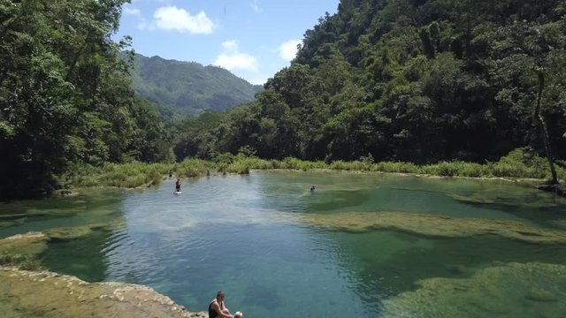 AERIAL: People in Semuc Champey waterfalls in Guatemala