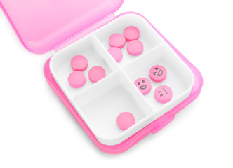 Box and pills with drawn faces on white background