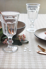  tableware on the festive table, close-up. glass cup and spoon on the table.